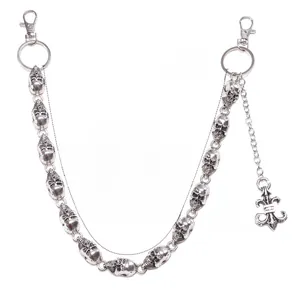 Detail of silver alloy pants chain featuring skull links and a fleur-de-lis pendant charm
