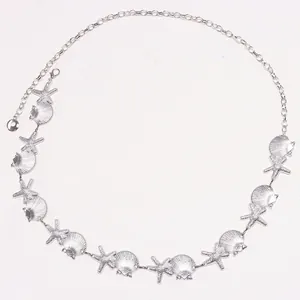 Detail of silver starfish and shell waist chain with pearls and lobster clasp
