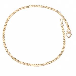 Detail view of gold alloy metal waist chain featuring heart buckle and lobster clasp specs