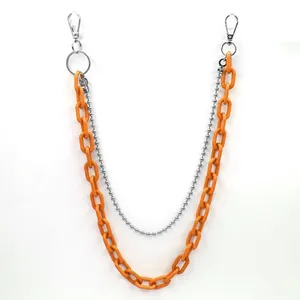 Close-up of vibrant orange acrylic chunky chain and silver bead layer pants chain