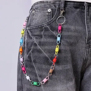 Colorful layered spring pants chain accessory with metal lobster clasp on grey denim jeans