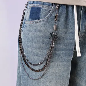 Punk multi-layer metal waist chain with spider pendant on light blue washed denim jeans