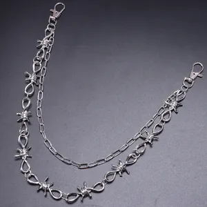 Detail of silver double-layered punk pants chain with barbed wire and paperclip links