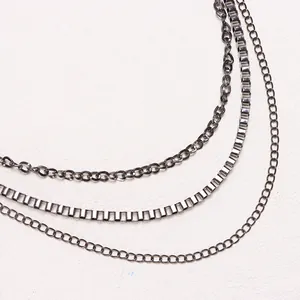 Detail of multi-layered gunmetal hip hop waist chains with box and round link textures