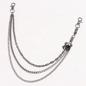 Detail of multi-layer gunmetal hip hop waist chain featuring a black spider pendant