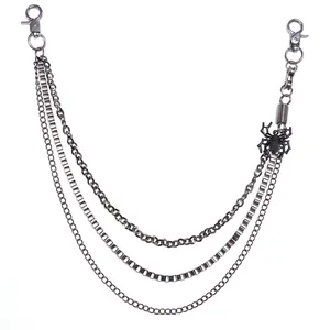 Detail view of gothic triple-layer metal wallet chain with a black spider pendant charm