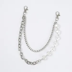 Detail of hip hop waist chain with silver metal links and irregular white pearls