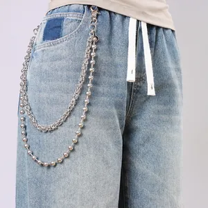 Double-layered silver metal wallet chain with bead and link strands on blue jeans