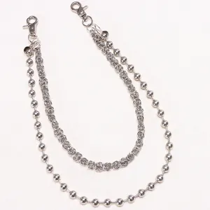 Detail of silver double-layered trousers chain with round beads and woven links