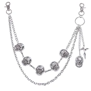 Detail of multi-layer silver hip hop wallet chain with 5 skulls and cross pendant charms