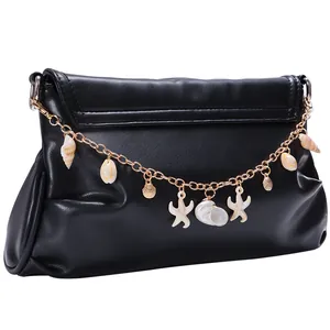 Detailed view of black PU leather clutch featuring gold chain with starfish and shell charms