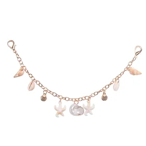 Macro view of ocean-themed metal chain with starfish shells and lobster clasps