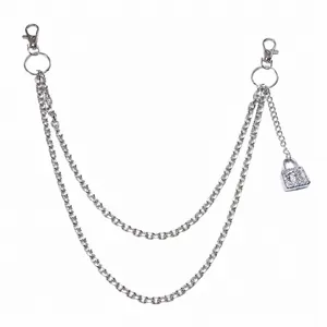 Detail of silver multi-layer metal hip chain with skull and padlock pendant features