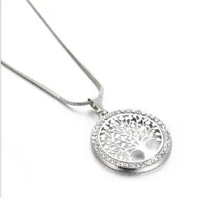 Detail shot of a silver tree of life pendant with sparkling crystal embellishments