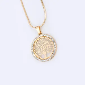 Close-up of golden Tree of Life pendant with white rhinestones and snake chain necklace