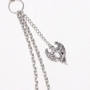 Close-up of silver metal trouser chain featuring a detailed eagle pendant and triple layers