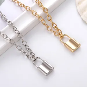 Retro gold and silver lock pendant necklaces with thick oval link chain on white background
