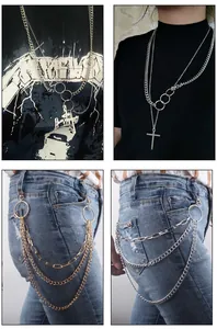 Detail of layered metal necklaces and waist chains with cross and ring pendants