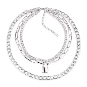 Layered silver necklace with cuban chains and lock pendant for women on white background