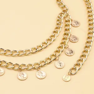 Close-up of gold coin belt featuring Queen Elizabeth II pendants and chunky metal chains