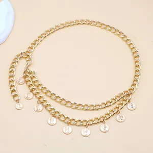 Detail of golden metal chain belt with dual layered tassels and queen coin charms