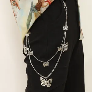 Detail of multi-layered silver butterfly hip chain with lobster clasp on black cargo pants