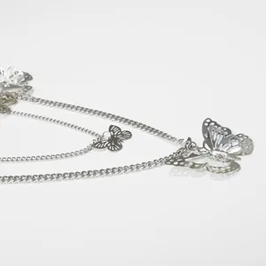 Multi-layer silver metal body chain with hollow butterfly charms in a tiered design