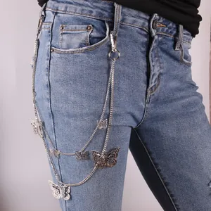 Silver multi-layer waist chain with hollow butterfly pendants on denim jeans