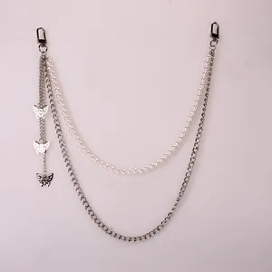 Detail of double-layer street pants chain with white pearls and hollow butterfly pendants
