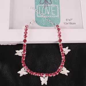Detailed close-up of butterfly anklet with pink rhinestones and silver-tone lobster clasp