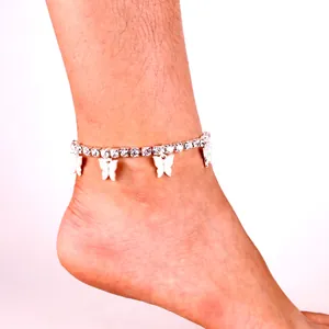 Close-up of sparkling rhinestone butterfly pendant anklet worn on a female ankle