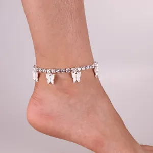 Elegant silver butterfly ankle bracelet with sparkling crystals on model's ankle