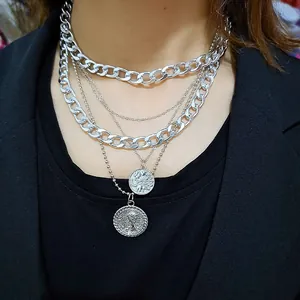 Vintage silver multi-layer necklace with coin pendants and cuban chain on black blazer