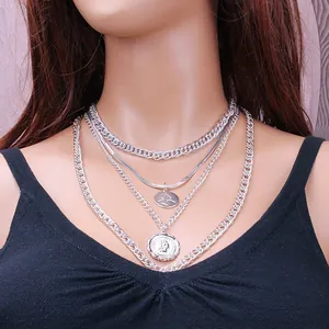 Layered silver chain necklace set with vintage coin pendants and horse relief charms