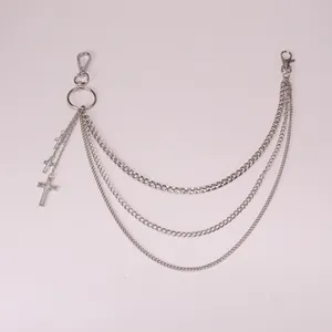 Close-up of triple-layered silver metal pants chain with punk style cross pendants
