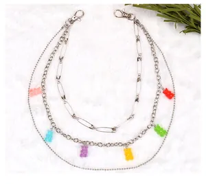 Detail view of triple-layered silver chains with colorful jelly gummy bear pendants