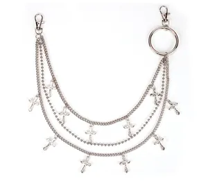 Detailed view of silver multilayer pants chain with metallic cross pendants and lobster clasps