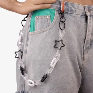 Close-up of street style acrylic star waist chain on denim pants for Y2K look
