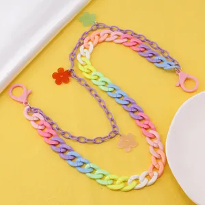 Detail view of colorful gradient acrylic double-layered chain with floral charms and lobster clasps
