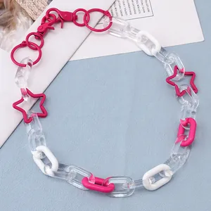 Detail of colorful acrylic star pants chain with pink, white and clear links