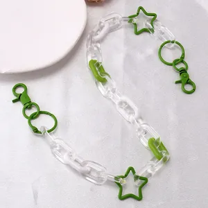 Detail of green and white acrylic chunky chain link accessory with star charms