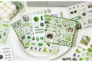 Detail view of green aesthetic stickers with nature, food, and alphabet motifs for journaling