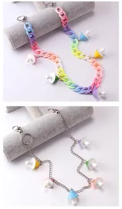 Detail of colorful acrylic chunky chain and silver metal link with mushroom charms