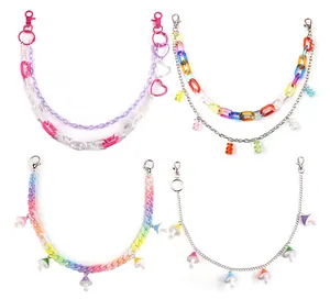 Detail of acrylic bear and mushroom charms with colorful chains and heart clasps