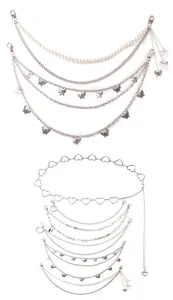 Close-up of multilayer silver waist chains with butterfly charms and pearl strand details