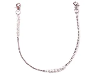Detailed view of silver metal chain with faux pearl accents and lobster clasps
