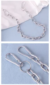 Close-up of polished silver metal pant chain with dual lobster clasps and ring detail