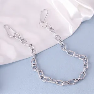 Punk silver metal pant chain with double snap hooks on blue and white silk background