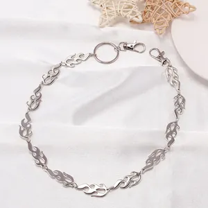 Detail of silver metal flame-shaped links and lobster clasps on hip hop style wallet chain