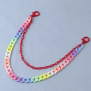 Close-up of double-layered resin chain with rainbow acrylic links and red lobster clasps